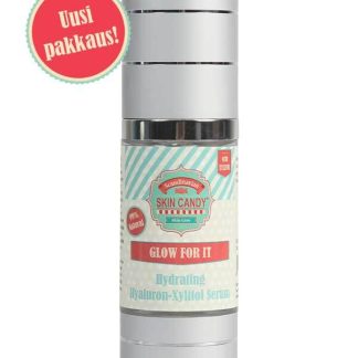 Skin Candy Glow for It hydrating hyaluronic–xylitol serum in a silver pump bottle with a red 'Uusi pakkaus!' sticker on the label, new packaging.