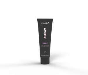 Black squeeze tube labeled "Vitality's Flowy Curl Extreme" standing upright on a dark textured surface with a soft shadow, a hair styling product