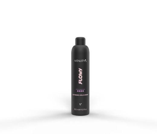Black bottle labeled Vitality's Flowy Extreme Hold Spray standing on a smoky surface with a dark backdrop (300 ml).