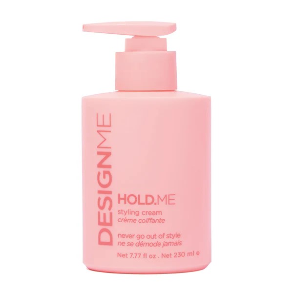 Pink DESIGNME HOLD.ME styling cream bottle with pump, front text visible: 'DESIGNME HOLD.ME styling cream' (net 7.77 fl oz / 230 ml)