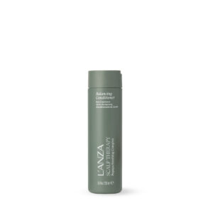 Tall green cylindrical bottle of L’ANZA hair care product on a white background.